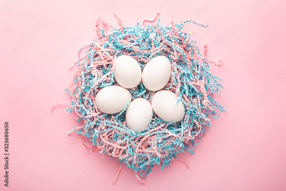 Easter creative composition. Flat lay with easter egg and kraft paper pink and blue filler on pink background.Minimal spring concept. Easter creative composition. Flat lay with easter egg and kraft paper pink and blue filler on pink background.Minimal spring concept.