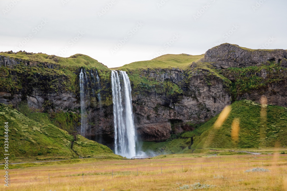 Fototapeta premium Seljalandsfoss Waterfall in Iceland. It is located near ring road of South Iceland. Majestic and picturesque, it is one of the most photographed breathtaking place of Iceland