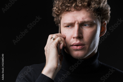 Portrait of a successful young attractive curly haired businessman