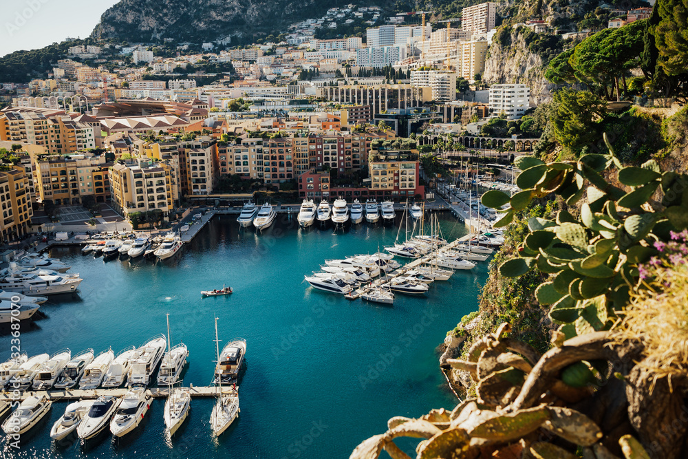Luxury yachts in the harbour of Monaco. Cityscape, French Riviera, Panorama. Panoramic view of Port de Fontvieille in Monaco. Azur coast. Colorful bay with a lot of luxury yachts on sunny day.