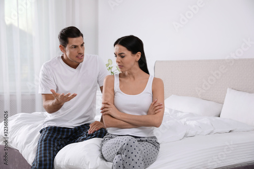 Couple with relationship problems quarreling in bedroom