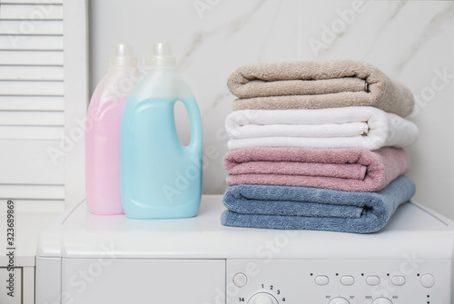 Stack of fresh towels and detergents in laundry room