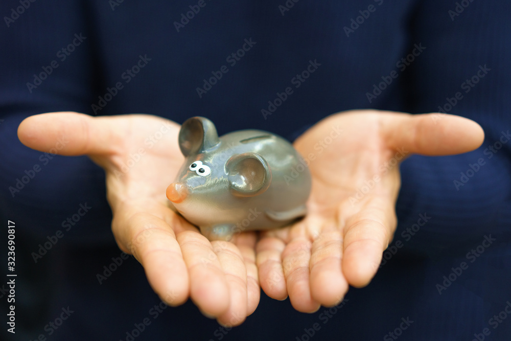 On the hand is a small figure of a mouse On the hand is a small figure of a mouse