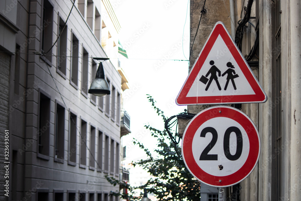 Traffic sign on the school road. There is a boy and girl student sign on it in the shape of a triangle. Traffic sign on the school road. There is a boy and girl student sign on it in the shape of a triangle.
