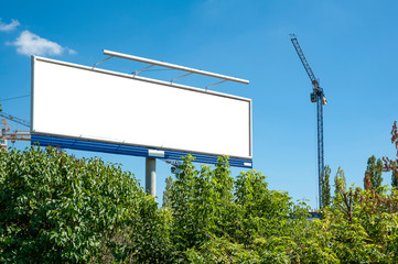 Huge blank white billboard for advertisement near construction site