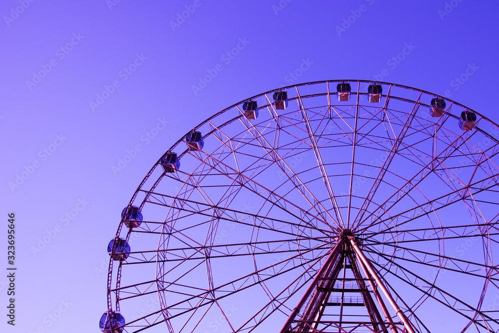 The outline of the Ferris wheel against the sky is a beautiful color.