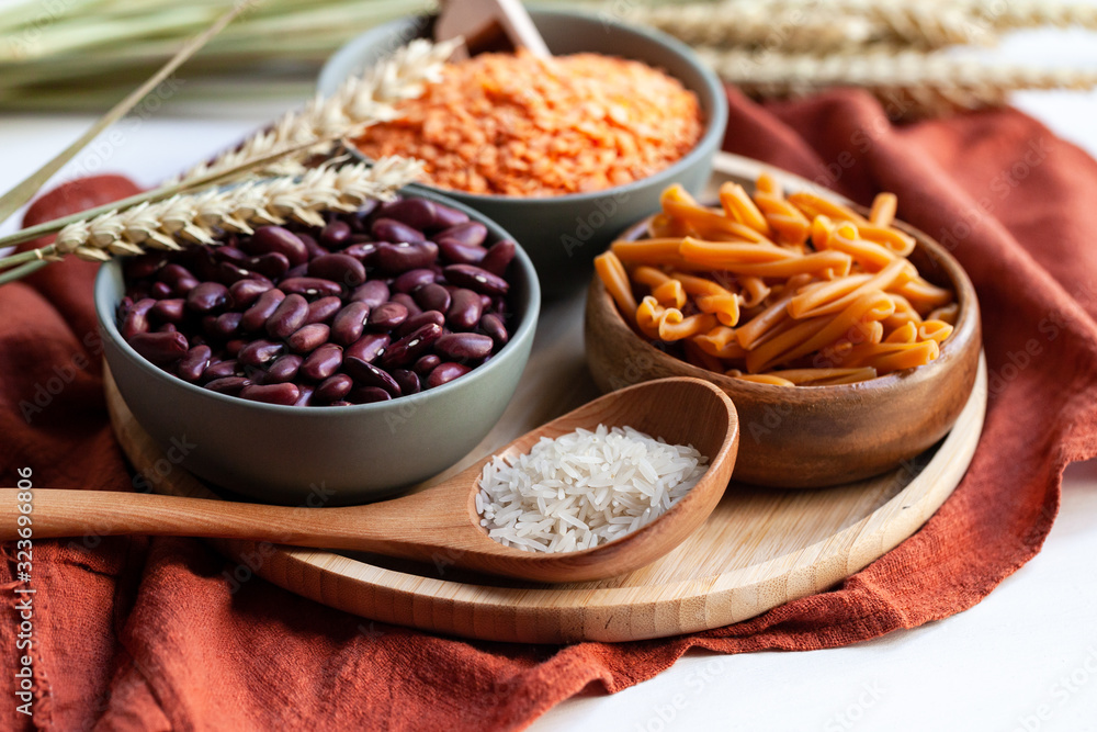 Fototapeta premium Vegan protein source. Beans, lentils, chickpea pasta. Healthy and tasty vegetarian food, ingredients ready for cooking. Front view, close up.