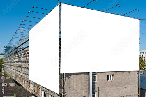Two blank white billboards for advertisement on the wall of industrial building