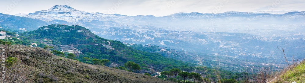 The mountains of Lebanon were once shaded by thick cedar forests and tree is the symbol of country. Beautiful landscape of mountainous town in winter, Eco tourism, Chouf district with large vistas