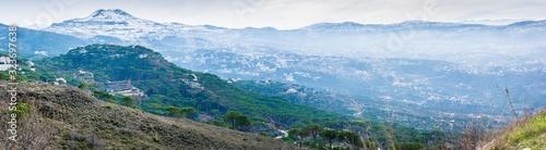Fototapeta Naklejka Na Ścianę i Meble -  The mountains of Lebanon were once shaded by thick cedar forests and tree is the symbol of country. Beautiful landscape of mountainous town in winter, Eco tourism, Chouf district with large vistas