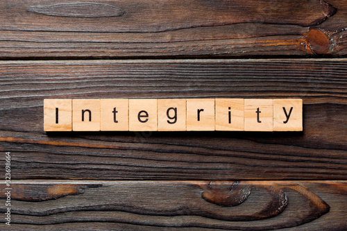 integrity word written on wood block. integrity text on table, concept photo