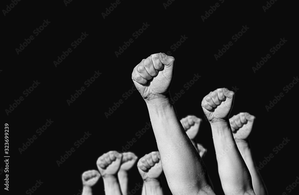 hands and fist raised in the air . the concept of the struggle and the retention of their rights and freedoms