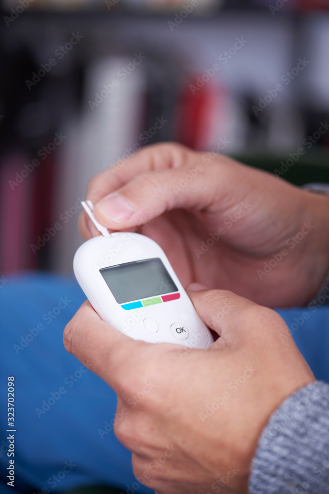 man about to measure his blood glucose level