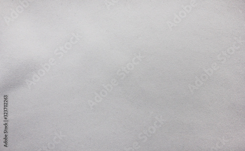 White texture background, light grey fabric pattern. Casual seamless cloth background, simple white fabric texture close up top view. Silky white surface, casual elegant sheet backdrop 