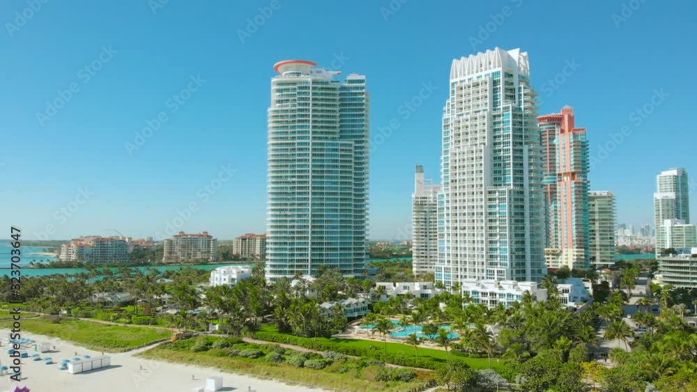 Miami Beach on a bright sunny day, aerial view. Drone flying forward near Miami Beach, South Beach, Florida. Cinematic video of a luxury resort in Miami South Beach. Holidays in Miami Touristic City. Miami Beach on a bright sunny day, aerial view. Drone flying forward near Miami Beach, South Beach, Florida. Cinematic video of a luxury resort in Miami South Beach. Holidays in Miami Touristic City.