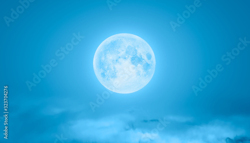 Night sky with moon in the clouds on the foreground dark bluesea  Elements of this image furnished by NASA