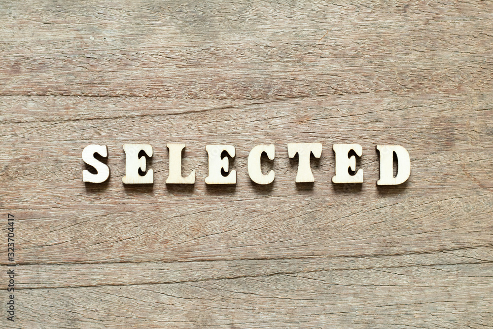 Fototapeta premium Letter block in word selected on wood background