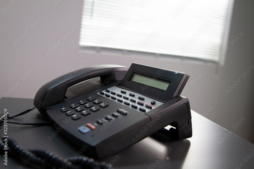 Black Office Telephone on a Grey Desk Black Office Telephone on a Grey Desk