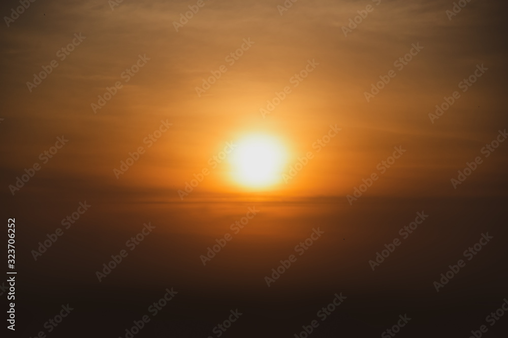 Orange Sun Sunset or sunrise sky above clouds with dramatic twilight before darkante or before the morning