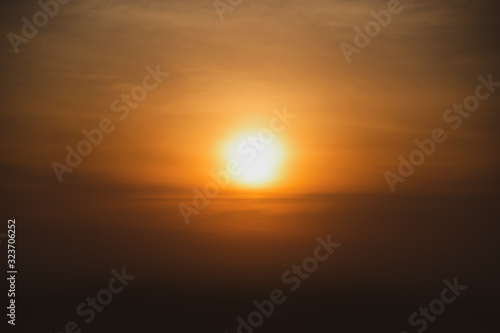 Orange Sun Sunset or sunrise sky above clouds with dramatic twilight before darkante or before the morning © jes2uphoto