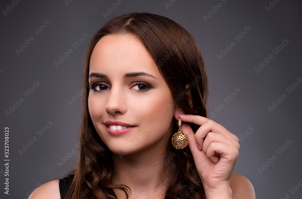 Young woman showing her new earrings Young woman showing her new earrings