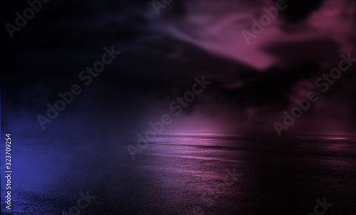 Background of empty stage show. Neon blue and purple light and laser show. Laser futuristic shapes on a dark background. Abstract dark background with neon glow