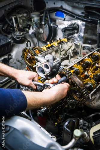 Car repair: overhaul of the V6 engine with detailed pulleys and parts.