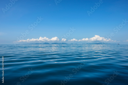 Blue Ocean with waves and clear blue sky Blue water surface. Travel destination and nature environment concept - Ocean water surface texture  summer holiday background
