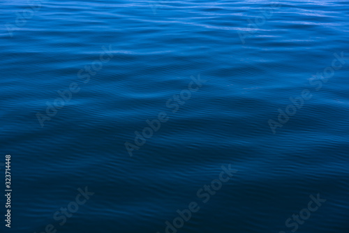 Fototapeta Naklejka Na Ścianę i Meble -  Blue water background with ripples Sea low angle view, Ocean, Wave.   Travel destination and nature environment concept - Ocean water surface texture, summer holiday background