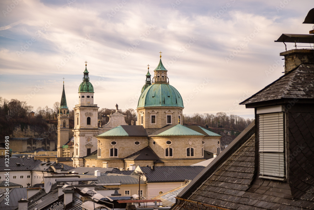 Impressive evening scenery over Salzburg: Rooftops of Cathedral, churches and houses