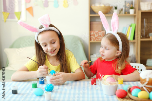 Children paint Easter eggs for the holiday.