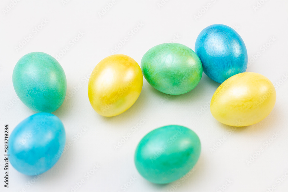 multicolored bright easter eggs on a white background, top view multicolored bright easter eggs on a white background, top view