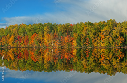 Autumn landscape of the shoreline of Moccasin Lake with mirrored reflections in calm water, Hiawatha National Forest, Michigan's Upper Peninsula, USA photo