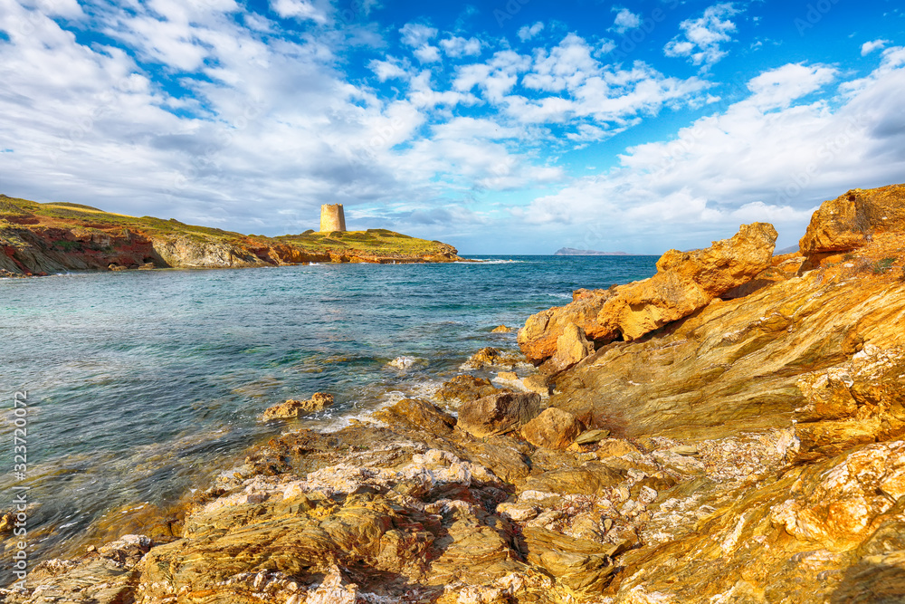 Gorgeous morning view of Piscinni bay with turquoise sea and famous coastal tower of Piscinni.