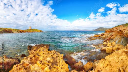 Fantastic morning view of Piscinni bay with turquoise sea and famous coastal tower of Piscinni. photo