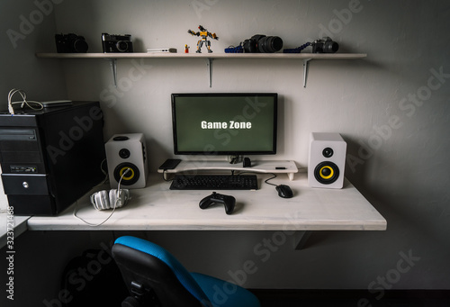 The workplace of a professional gamer with a monitor, gamepad, headphones and an armchair.