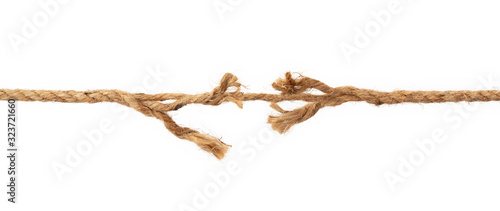 Long, old frayed rope is breaking off. Isolated on white.