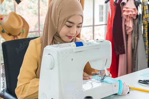 Muslim Woman Creative Fashion Designer is Working owner working in Tailor Shop.