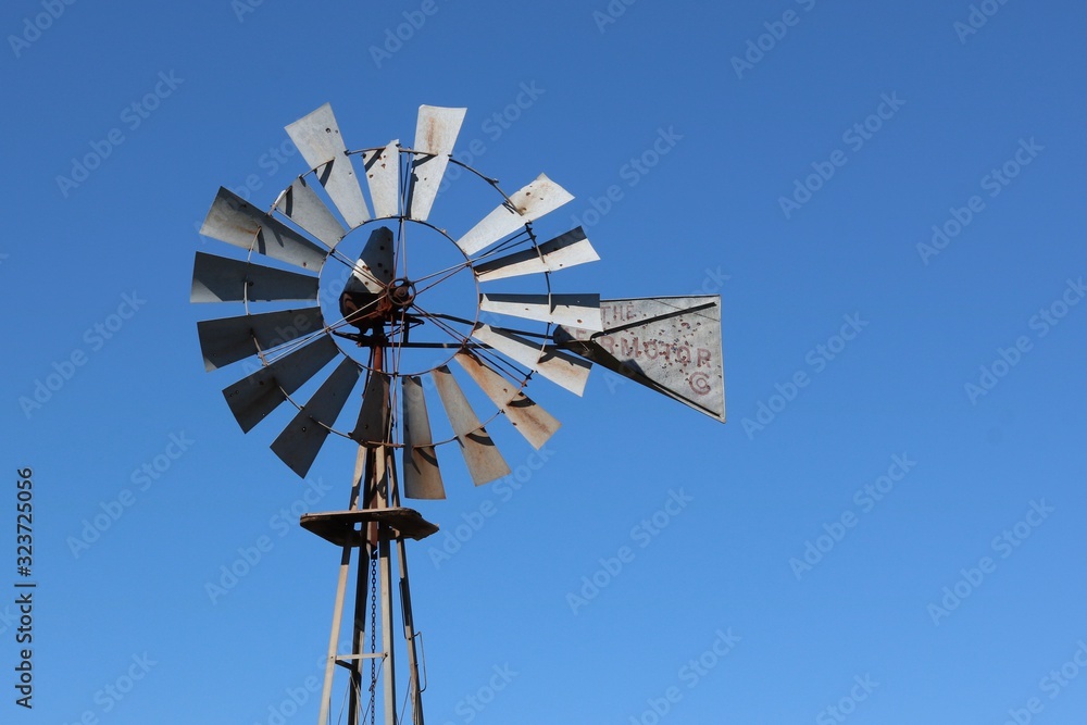 Closeup of an old windmill against a blue sky with copy space Closeup of an old windmill against a blue sky with copy space