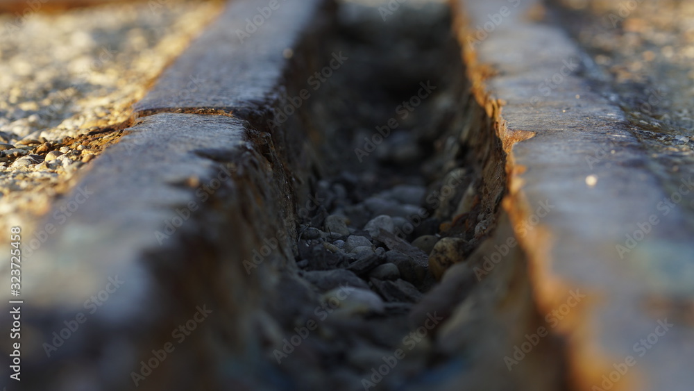 Macro shot of an abandoned rusty train rail in sunset light Macro shot of an abandoned rusty train rail in sunset light
