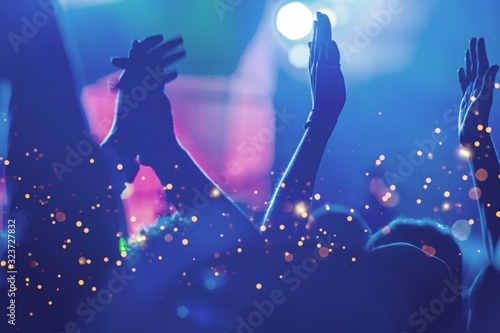 Audience with hands raised at a music festival