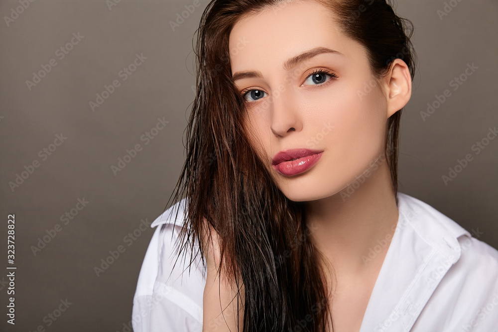 Close-up of a young white lady with loose wet hair. Close-up of a young white lady with loose wet hair.