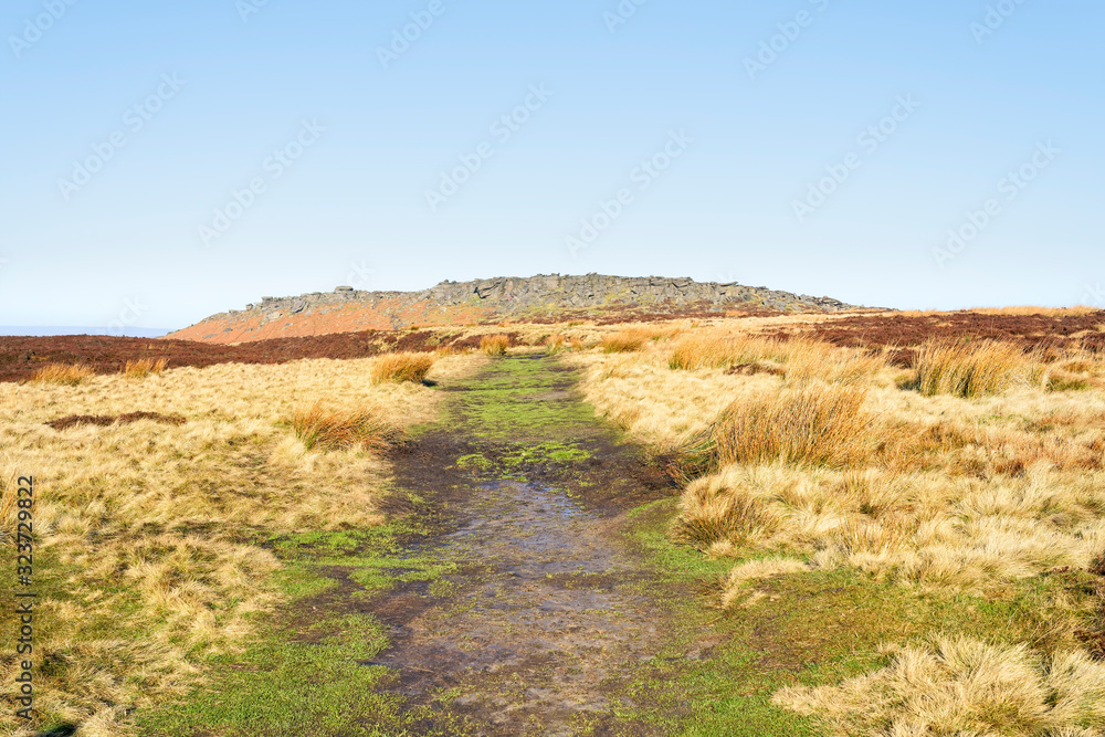 Wide footpath leads up to Stanage Edge in the Derbyshire Peak District Wide footpath leads up to Stanage Edge in the Derbyshire Peak District