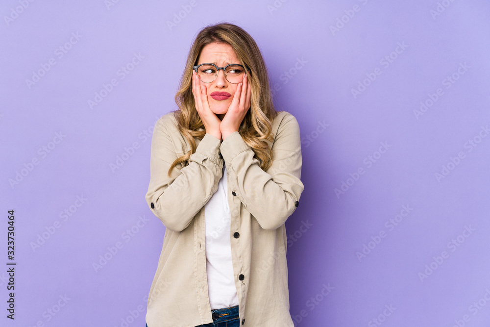 Young caucasian woman isolated on purple background whining and crying disconsolately. Young caucasian woman isolated on purple background whining and crying disconsolately.