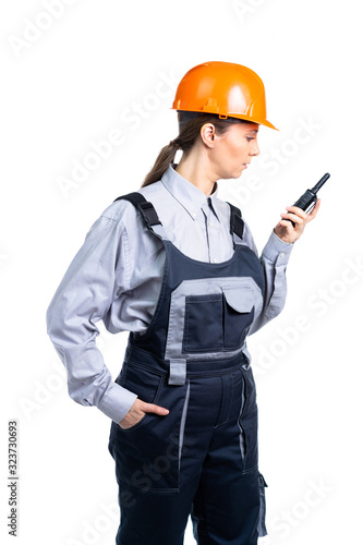 Girl builder talking on the walkie-talkie. isolated