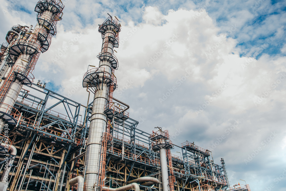 Fototapeta premium Industrial zone,The equipment of oil refining,Close-up of industrial pipelines of an oil-refinery plant,Detail of oil pipeline with valves in large oil refinery.