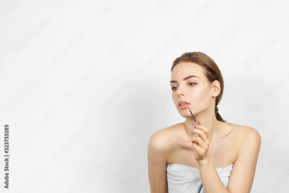 Beautiful sensual woman in a towel with Lip brush Beautiful sensual woman in a towel with Lip brush