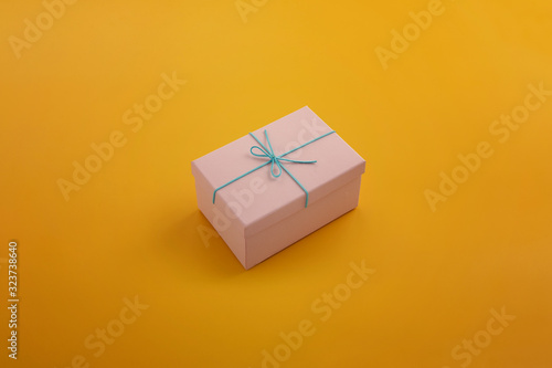 Fototapeta Naklejka Na Ścianę i Meble -  Gift box in a yellow background, minimalism design.