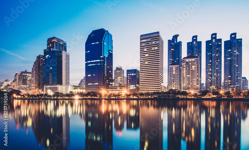 Business district cityscape from park,Benchakitti Park in Morning with cityscape reflection, Bangkok Thailand.