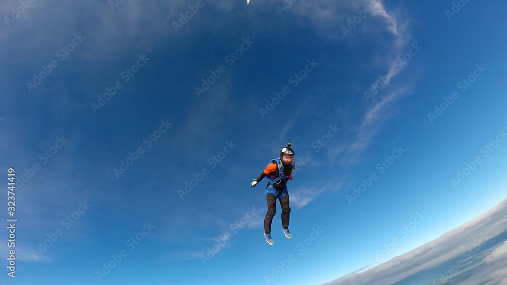 Fitness. Skydiver engaged in air fitness. Man soars in the sky like a bird. Team of professionals.